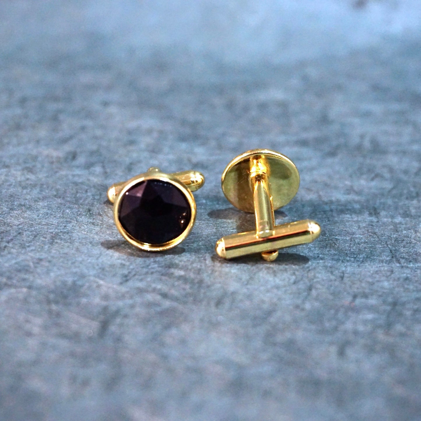 black faceted cufflnks on gold backing